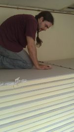 Measuring and cutting insulation.