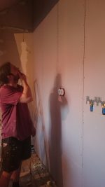 Putting up plasterboards.