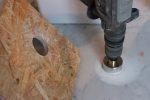 We were unaware of templates for core drills, I just read about them yesterday.
Too late to order any, so we made our own with a piece of OSB, which worked
perfectly. You only need to use it until you have a groove (first pic).